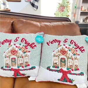 2 Pioneer Woman Holiday Pillows featuring sweet Gingerbread houses